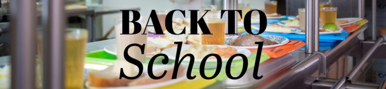 Back to school concept with blurred school cafeteria lunch line showing students and food service equipment